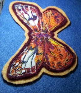 Butterfly brooch attachingh first felt layer