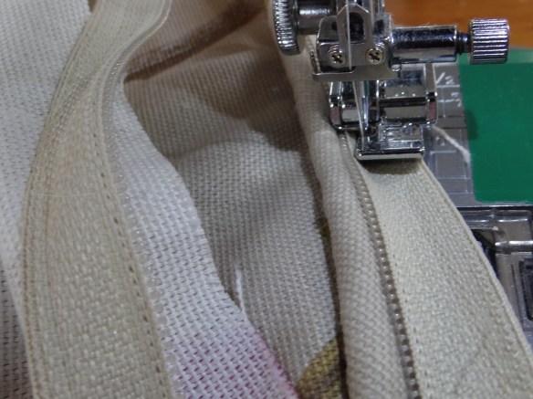 Sew in zip so teeth sit on piping